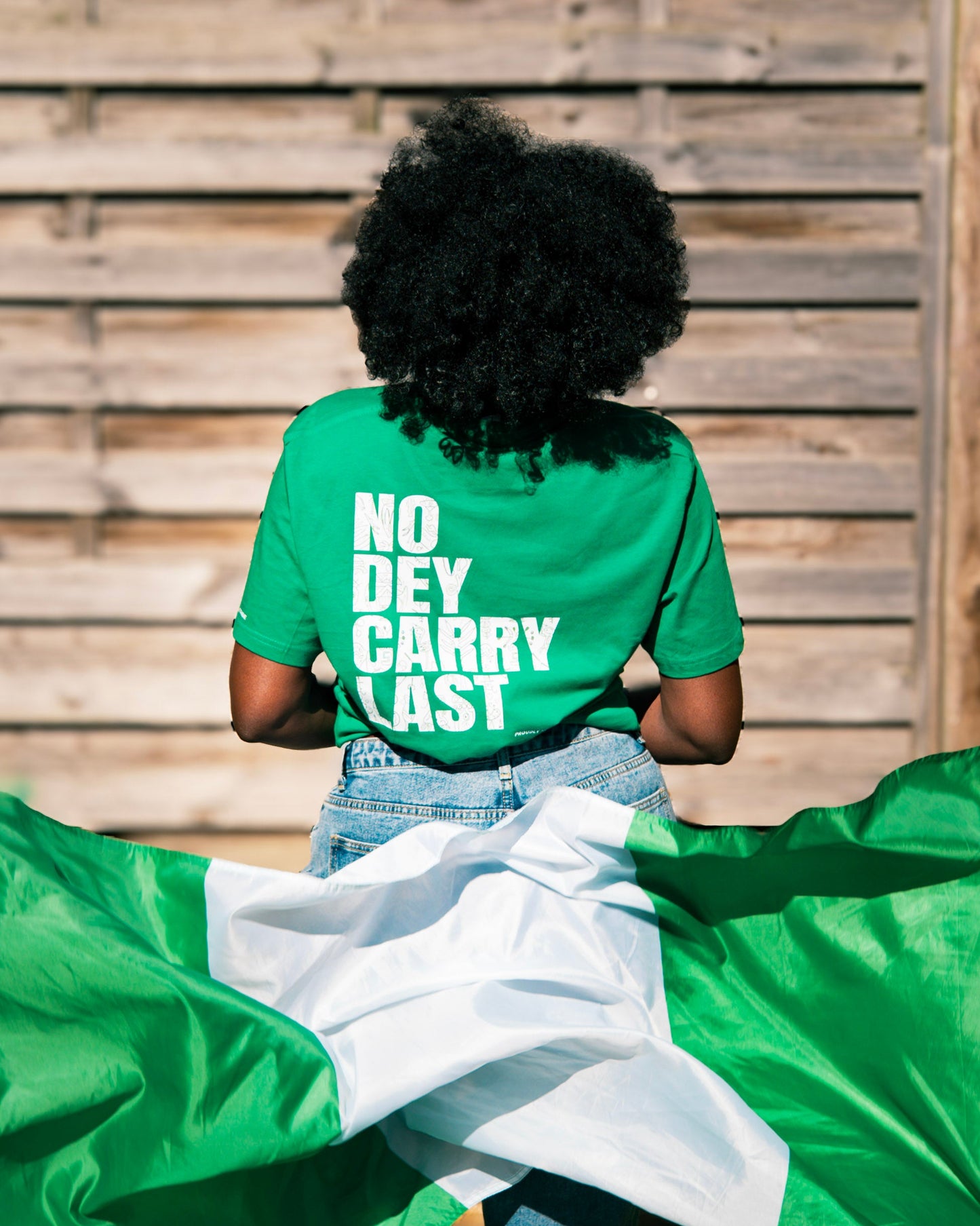 Green t-shirt with Nigerian flag in motion, celebrating African basketball culture