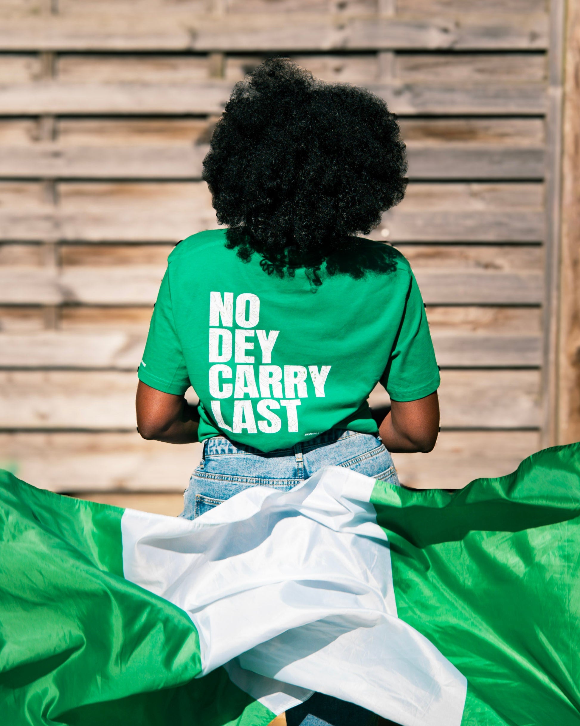 Green t-shirt with Nigerian flag in motion, celebrating African basketball culture